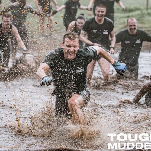 Excited runners plough through a very wet and muddy stretch of the course